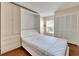 Bright bedroom featuring a murphy bed, built-in storage, and wood flooring at 12006 Stone Crossing Circle, Tampa, FL 33635