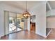 Dining area with hardwood floors, a modern chandelier, and sliding glass doors to the outdoor space at 12006 Stone Crossing Circle, Tampa, FL 33635