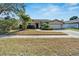 Charming single-story home features a well-manicured lawn, mature landscaping, and a two-car garage at 12006 Stone Crossing Circle, Tampa, FL 33635