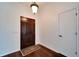 Foyer with hardwood floors, a decorative rug, and a stylish dark wood front door at 12006 Stone Crossing Circle, Tampa, FL 33635