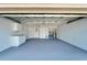 Clean, empty garage with a painted floor and a door to the interior at 12006 Stone Crossing Circle, Tampa, FL 33635