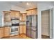 Modern kitchen features stainless steel refrigerator, glass-front cabinets, and a pantry at 12006 Stone Crossing Circle, Tampa, FL 33635