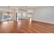 Open-concept living area featuring hardwood floors, a mirrored wall, and sliding glass doors to the patio at 12006 Stone Crossing Circle, Tampa, FL 33635