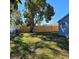 Large backyard with a wooden fence and mature tree at 13625 120Th St, Largo, FL 33778