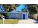 Charming single-story home with a well-manicured front yard and a striking blue front door at 13625 120Th St, Largo, FL 33778