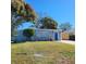 Charming light blue house with a blue front door and well-maintained lawn at 13625 120Th St, Largo, FL 33778