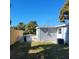 Side view showing house exterior, fenced yard, and AC unit at 13625 120Th St, Largo, FL 33778