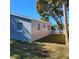 Side view of a freshly painted light blue house with a large tree in the yard at 13625 120Th St, Largo, FL 33778