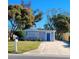 Front view of charming house with blue door and landscaping at 13625 120Th St, Largo, FL 33778