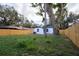 Fenced backyard with lush lawn and large shade tree at 3014 E Osborne Ave, Tampa, FL 33610