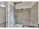 A modern shower features a rainfall shower head and stylish mosaic tile accents at 5028 School Rd, Land O Lakes, FL 34638