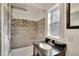 Stylish bathroom features a rainfall shower head, mosaic tile accents, and a granite-topped vanity at 5028 School Rd, Land O Lakes, FL 34638