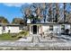 Charming single-story home with stone accents, manicured landscaping, and a welcoming entrance at 5028 School Rd, Land O Lakes, FL 34638