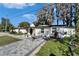 Beautifully renovated single-story home featuring a modern walkway and a well-maintained front yard at 5028 School Rd, Land O Lakes, FL 34638