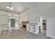 Spacious living room featuring stone fireplace, built-in shelving, and abundant natural light at 5028 School Rd, Land O Lakes, FL 34638