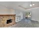 Open-concept room featuring a stone fireplace and sliding glass doors to the outdoors at 5028 School Rd, Land O Lakes, FL 34638