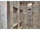 Modern shower with unique tiling, multiple shower heads, and built-in shelving at 5028 School Rd, Land O Lakes, FL 34638