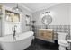 Modern bathroom with hexagon tile floors, a soaking tub, and a walk-in shower at 554 6Th N Ave, St Petersburg, FL 33701