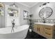 Updated bathroom with freestanding tub and black hexagon tile at 554 6Th N Ave, St Petersburg, FL 33701