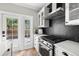 Modern kitchen with stainless steel appliances and a black hexagon backsplash at 554 6Th N Ave, St Petersburg, FL 33701