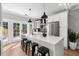 Modern kitchen with white cabinets, a large island, and stainless steel appliances at 554 6Th N Ave, St Petersburg, FL 33701