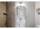 Updated bathroom with pedestal sink, shower, and modern fixtures at 8814 Bay Pointe Dr # 204, Tampa, FL 33615