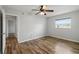 Bright bedroom with wood-look floors and ceiling fan at 8814 Bay Pointe Dr # 204, Tampa, FL 33615