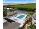 Community pool with lounge chairs and waterfront view at 8814 Bay Pointe Dr # 204, Tampa, FL 33615