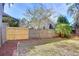 Backyard with wooden fence, grass, and trees at 2529 Clareside Dr, Valrico, FL 33596