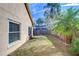 Spacious backyard with grass, trees, and wooden fence at 2529 Clareside Dr, Valrico, FL 33596