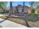 Tan house exterior with landscaped yard and driveway at 2529 Clareside Dr, Valrico, FL 33596