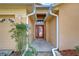 Front entry with red door and landscaping at 2529 Clareside Dr, Valrico, FL 33596