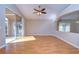Spacious living room featuring wood floors and sliding glass doors at 2529 Clareside Dr, Valrico, FL 33596