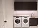 Modern laundry room with Whirlpool appliances and dark cabinetry at 777 3Rd N Ave # 1605, St Petersburg, FL 33701