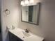 Bathroom features vanity with sink, mirror, and tiled floor at 208 Nina Way # 208, Oldsmar, FL 34677