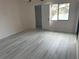 Bright bedroom with wood-look floors and walk-in closet at 208 Nina Way # 208, Oldsmar, FL 34677