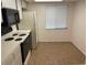 Simple kitchen with white cabinets, microwave, and stovetop at 208 Nina Way # 208, Oldsmar, FL 34677