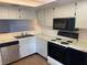 Bright kitchen with stainless steel appliances and white cabinets at 208 Nina Way # 208, Oldsmar, FL 34677