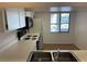 White kitchen cabinets, black appliances, and a window at 208 Nina Way # 208, Oldsmar, FL 34677