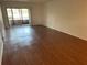 Living room with wood-look floors and sliding doors to balcony at 208 Nina Way # 208, Oldsmar, FL 34677