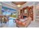 Living area with pool view, featuring comfortable leather sofas and a large ottoman at 20953 Broadwater Dr, Land O Lakes, FL 34638