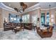 Relaxing living room with leather furniture, large windows, and a cozy atmosphere at 20953 Broadwater Dr, Land O Lakes, FL 34638