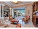 Living room with sliding doors opening to the pool and patio, leather furniture at 20953 Broadwater Dr, Land O Lakes, FL 34638