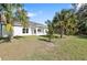 Spacious backyard with covered patio and lush landscaping at 4551 Wilcox Ave, North Port, FL 34288