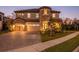 Two-story home with stone accents, three-car garage, and landscaped yard at 13019 Paddock Wood Pl, Riverview, FL 33579