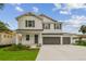Two-story house with gray shutters, white siding, and a two-car garage at 1530 W River Shore Way, Tampa, FL 33603