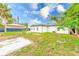 Newly built home with fenced backyard, grassy area, and concrete slab at 4008 W Leila Ave, Tampa, FL 33616
