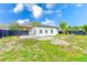 Newly built home with a fenced backyard and grassy area at 4008 W Leila Ave, Tampa, FL 33616