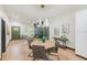 Modern dining area with round table and four chairs, hardwood floors, and stylish lighting at 4008 W Leila Ave, Tampa, FL 33616