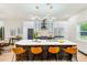 Modern kitchen with marble island, stainless steel appliances, and stylish lighting at 4008 W Leila Ave, Tampa, FL 33616
